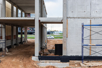 Construction of a reinforced concrete building. Elements of a concrete house. Structural elements. Construction site. Foundations and grillages.