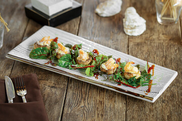 Portion of gourmet baked stuffed mushrooms on wooden background
