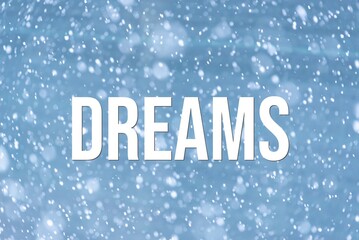 DREAMS - word on the background of the sky with clouds.