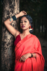 Fototapeta premium fashion photo of beautiful woman wearing Red saree bright makeup, posing outdoor