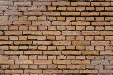 yellow worn brick wall