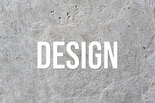 DESIGN - word on concrete background. Cement floor, wall.