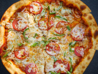 Vegetarian cheese Pizza in india topped with tomatoes, capsicum and onion. Indian veg pizza