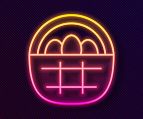 Glowing neon line Basket with easter eggs icon isolated on black background. Happy Easter. Vector