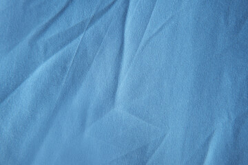 Old used wrinkled empty light Blue color tone bedsheet cloth texture minimalist background