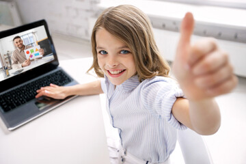 education, online school and technology concept - smiling student girl with laptop computer and teacher on screen showing thumbs up at home