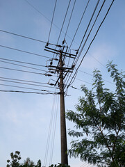 Electricity pole and power line under the blue sky