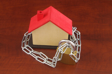 Chained house with padlock and chain. Safety home concept.