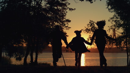 Fototapeta na wymiar Silhouette daughter couple running at river sunset view. Caring people together.