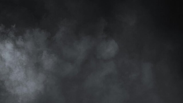 Abstract white smoke in slow motion. white smoke on a black background . 4k ice smoke cloud.   green screen . Floating fog.