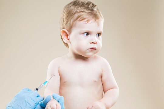Medical Concepts. One Sad Little Caucasian Boy Is Beeing Vaccinated with Protective Vaccine.