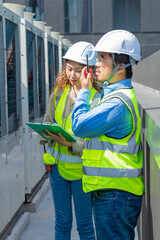 Engineer under checking the industry chilled water fan coil unit air conditioner is water cooling tower air chiller HVAC system of large industrial building to control air system
