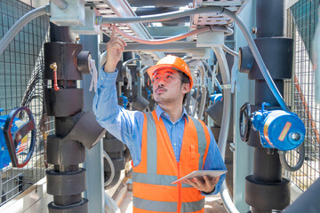 Engineer under checking the industry chilled water fan coil unit air conditioner is water cooling...