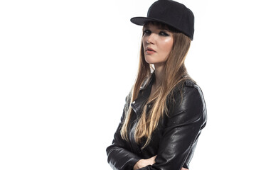 Sporty Caucasian Winsome Blond Sexy Girl in Leather Jacket And Fitness Skinny Outfit While Posing in Black Cap Over Pure White Background.