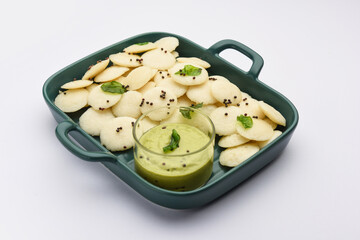 Mini idli is the smaller version of soft and spongy round shaped steamed regular rice idli, also known as button and cocktail idly