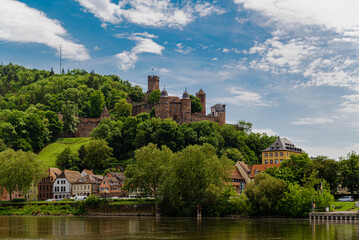 Fototapeta na wymiar Burg Wertheim Landscape Photo with Cloudy Sky. medieval Castle in Germany Next to Majna River in a beautiful valley. German name is Burg Werheim. Amazing view in clear daylight