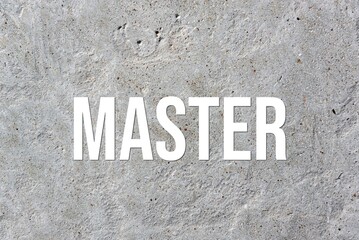 MASTER - word on concrete background. Cement floor, wall.