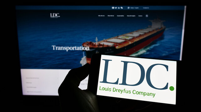 Stuttgart, Germany - 06-12-2022: Person holding cellphone with logo of Louis Dreyfus Company BV (LDC) on screen in front of business webpage. Focus on phone display.