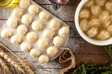 Semi finished pelmeni dumplings on wooden board