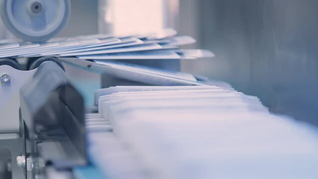 Close up, Automatic line for printing in the printing house.