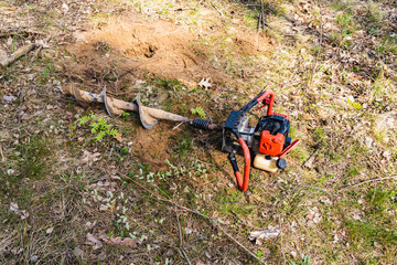 Manual petrol tool for drilling holes. Holes for fence posts. Manual drill for drilling wells.