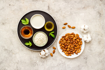 Sweet almond oil and milk with nuts seeds. Healthy food and cosmetic background