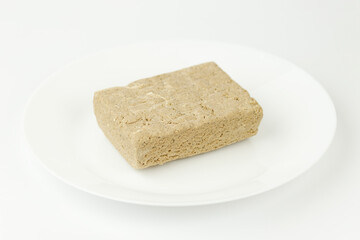 Sweet oriental dessert - halva on a white background.