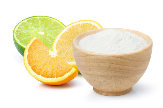 Baking soda or sodium bicarbonate powder and citrus fruits isolated on white background. Citric acid powder.