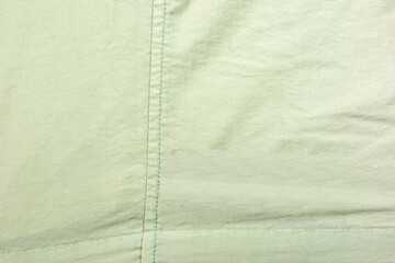 Bright fabric with thread stitching as texture.