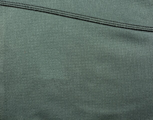 Clothing industry. Dark fabric with a pattern and machine seam. - 511464107