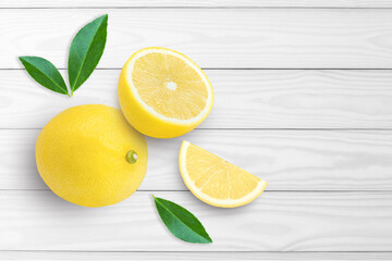 lemon with leaves on wooden table