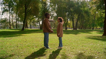 Fototapeta premium Happy father touching noses with smiling daughter in golden sunlight portrait.