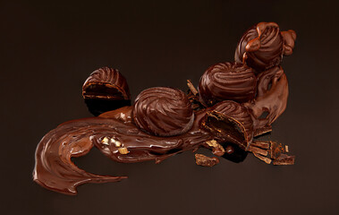 chocolate candies with filling on black background
