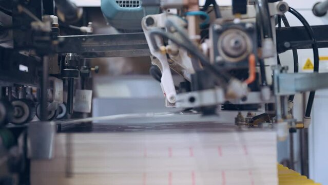 Close up, Automatic line for printing and cutting in the printing house.