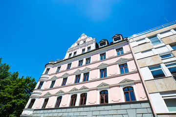 Fototapeta na wymiar Rows of houses, apartment buildings, condominiums in Schwabing, blue sky