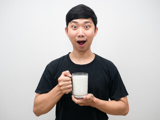 Young man holding milk glass excited emotion portrait