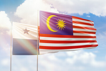 Sunny blue sky and flags of malaysia and panama