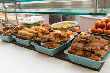 Typical Israeli breakfast buffet at any hotel.  Jachnun or Jahnun, Yemenite Jewish pastry, served with fresh grated tomato and boiled egg and Zhug
