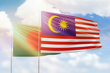 Sunny blue sky and flags of malaysia and bangladesh