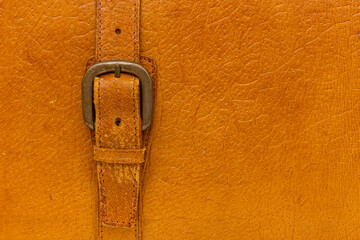 Belt clasp on a retro suitcase. Connection close-up.