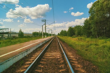 Obraz na płótnie Canvas Railway tracks tend to the horizon and the sky