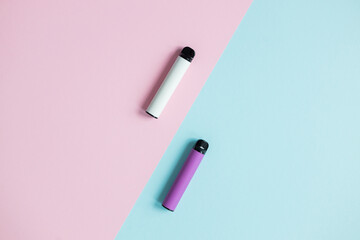 Modern disposable electronic cigarettes on color background