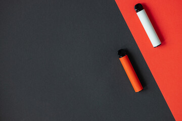 Modern disposable electronic cigarettes on color background