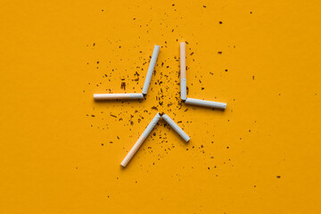 Broken cigarettes on a yellow background. Smoking kills.No smoking concept. No tobacco day