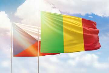 Sunny blue sky and flags of mali and czechia