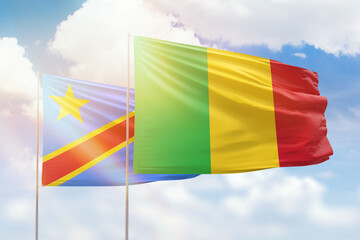 Sunny blue sky and flags of mali and dr congo