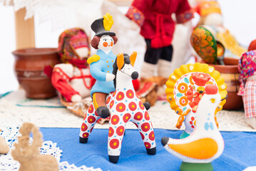 Russian national toys made of clay. Nesting dolls of different types. Utensils for playing....