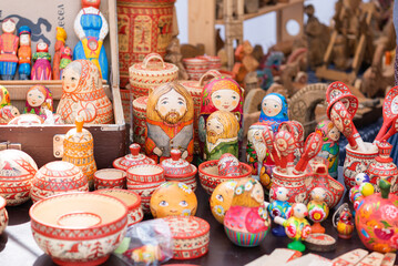 Russian folk toys made of wood. Nesting dolls of different types. Wooden items. utensils for playing. Festival of Nationalities and Religions.