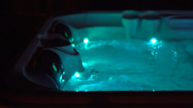 Night scene. A hot tub on a rooftop at night with candles on its side