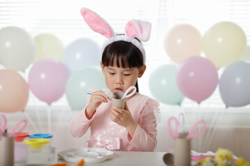 young girl making easter craft at home